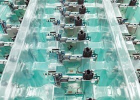 Detailed view of organized electronic circuit boards in a production setting.